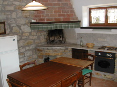 The interior of Querciolaie 2 has a comfortable layout with an inviting kitchen area.