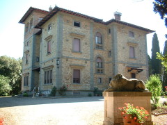 The main villa at Querciolaie is surrounded by elegant gardens.